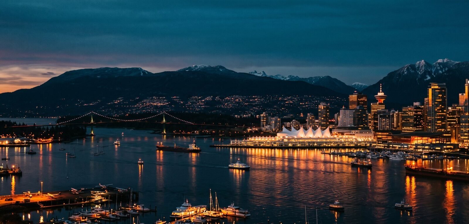 Vancouver harbour at dusk with Canada Place and the North Shore mountains