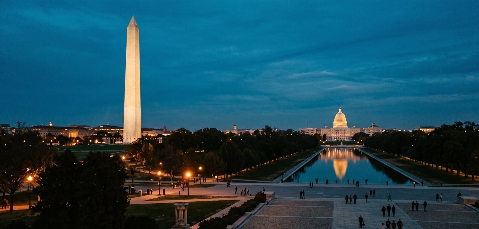 The Washington Monument and the Capitol at dusk above the Reflecting Pool